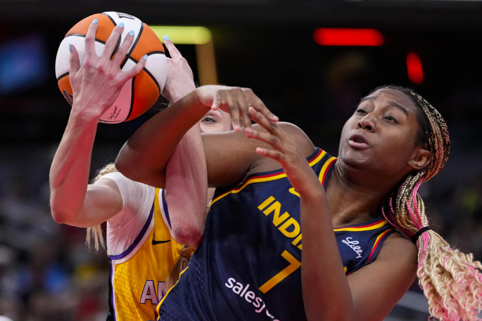 Indiana Fever forward Aliyah Boston (7) is fouled by Los Angeles Sparks forward Cameron Brink (22) in the first half of a WNBA basketball game in Indianapolis, Tuesday, May 28, 2024. (AP Photo/Michael Conroy)