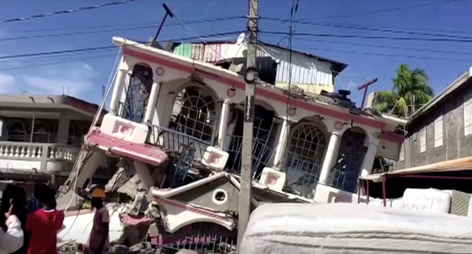 A view of a collapsed building following an earthquake, in Les Cayes, Haiti, in this still image taken from a video obtained by Reuters on August 14, 2021. Source: Reuters 