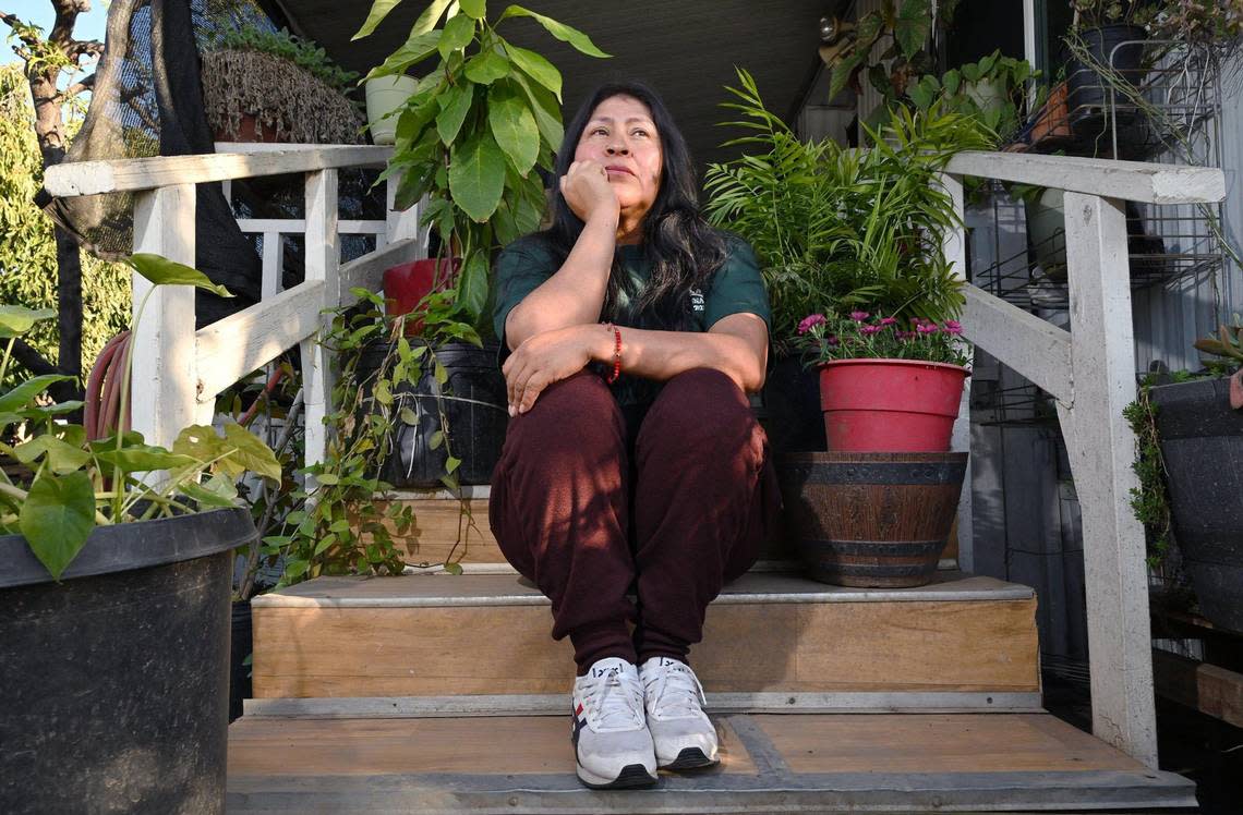 Xochilt Nuñez, who immigrated from Mexico in 1999 and has spent years advocating for farmworker and immigrant rights, sits on her steps at home in Orosi last month. To her, it is difficult to see these new arrivals seemingly receive tons of support while she has struggled for years and still has no realistic chance of citizenship. 