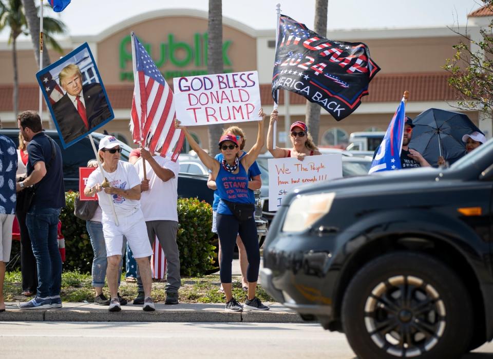 Supporters of former President Donald Trump wave signs and flags during a rally on Monday, April 3, 2023, in West Palm Beach, Florida. (AP)