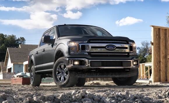 A gray 2018 Ford F-150 pickup, parked on a construction site.