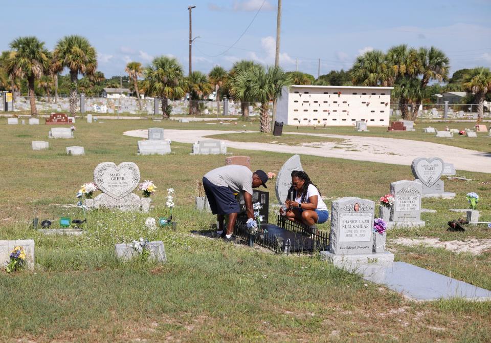 Clover Anderson (right) and her friend Naarl Richard, both of Fort Pierce, clean and place fresh flowers at the gravesite of Anderson's son, Akiefe Jamal Anderson, on Saturday, Aug. 12, 2023, at Riverview Memorial Park in downtown Fort Pierce. "This is my weekly life," said Anderson. "We keep him clean because that's the person he was, neat and clean and good." Akiefe, 22, was found with a gunshot wound about 2:45 a.m. on Aug. 28, 2021 on Avenue M Extension east of U.S. 1 north in Fort Pierce. St. Lucie County Sheriff's Office has not announced any arrests but said they are trying to find a 2012 silver Ford Focus in connection with the homicide.