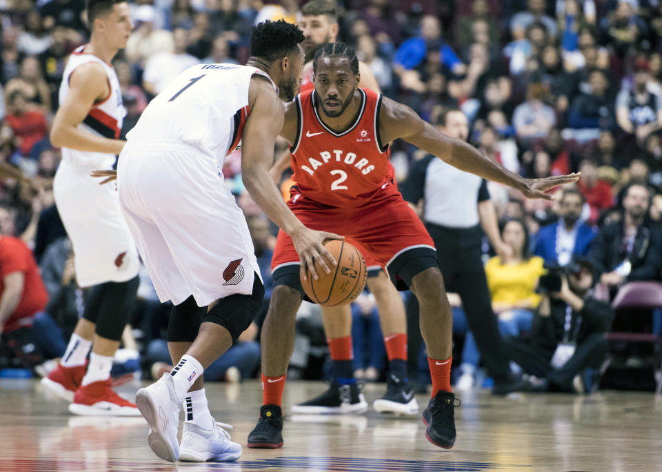 Toronto Raptors forward Kawhi Leonard (2) fights for control of the ball with Portland Trail Blazers guard Evan Turner (1) during the first half of a preseason NBA basketball game, Saturday, Sept. 29, 2018 in Vancouver, British Columbia. (Jonathan Hayward/The Canadian Press via AP)