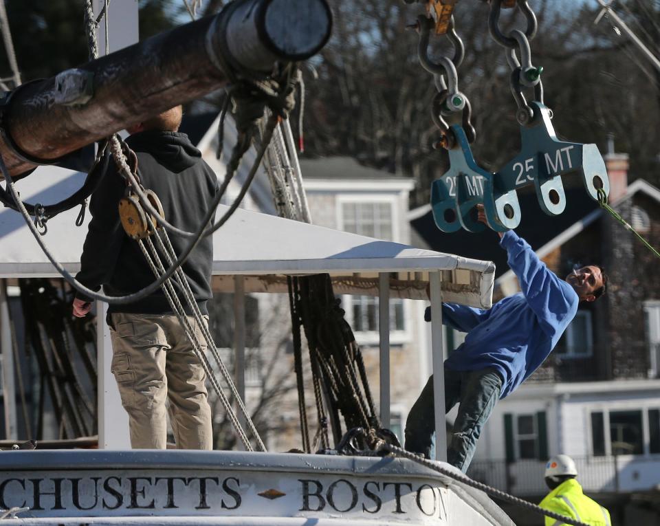 Workers take special caution while removing the Spirit of Massachusetts from the Kennebunk River Nov. 28, 2023.