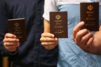 Voters show their documents in a polling station before closing vote for the presidential election in Tehran, Iran, May 19, 2017. TIMA via REUTERS