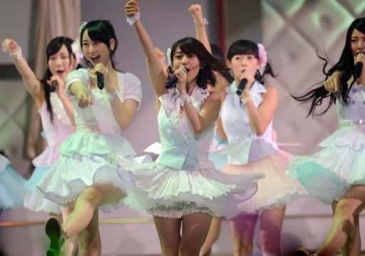 Yuko Oshima (C) and AKB48 group members perform during the AKB48 General Election show in Tokyo on June 6. Oshima dominated Thursday's newspapers after her victory in a popular ballot for the top spot in one of the world's highest grossing acts