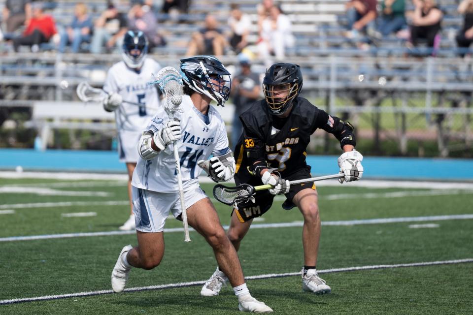 West Milford at Wayne Valley in the Passaic County boys lacrosse final on Saturday, May 6, 2023. WV #14 Alex Scheuplein tries to get past WM #33 Nash Appell.