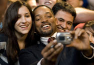 Actor Will Smith takes pictures with fans before a screening of his new movie "Seven Pounds" Thursday, Dec. 11, 2008 in Charlotte, N.C., at the Regal Stonecrest Theater. (AP Photo/Jason E. Miczek)