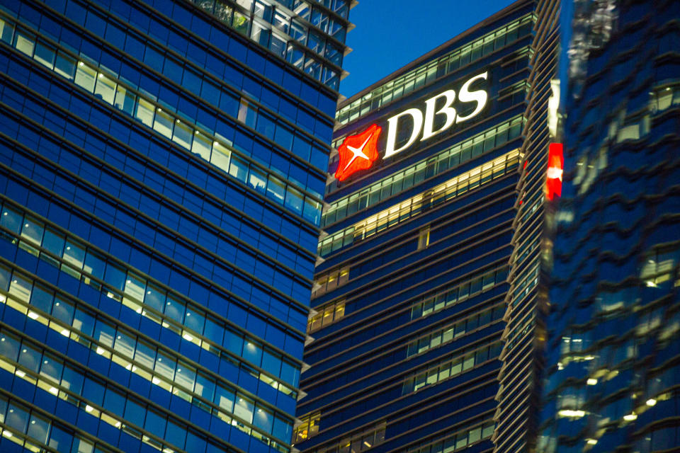 Illuminated signage is displayed on the DBS Group Holdings Ltd. bank building at night in the central business district of Singapore. (Photo: Getty Images)