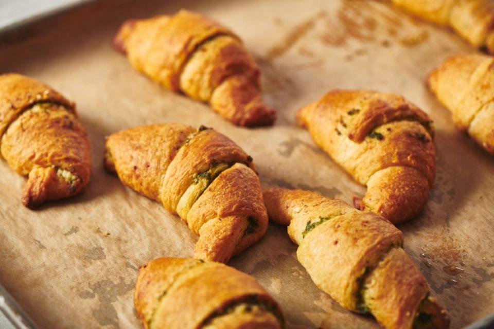 <p>Katie Workman</p><p>With a quick brush of pesto and a sprinkle of cheese refrigerated crescent rolls become something extra special. Rollin up the crescent rolls is a good kid activity.</p><p><strong>Get the recipe: <a href="https://themom100.com/recipe/pesto-crescent-rolls/" rel="nofollow noopener" target="_blank" data-ylk="slk:Pesto Crescent Rolls;elm:context_link;itc:0;sec:content-canvas" class="link ">Pesto Crescent Rolls</a></strong></p>