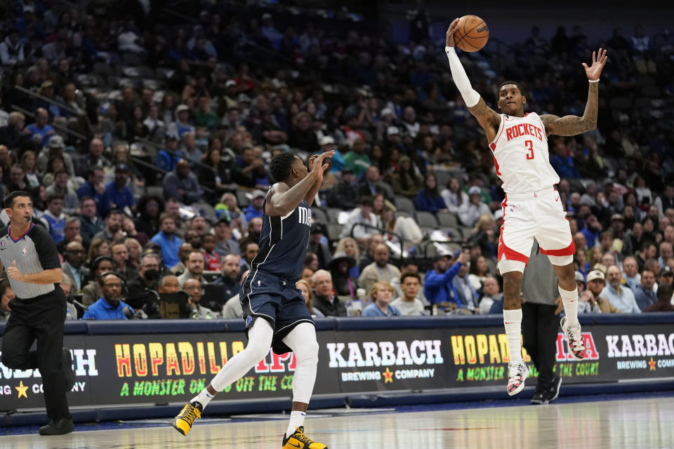 Houston Rockets guard Kevin Porter Jr. (3) steals a pass meant for Dallas Mavericks forward Dorian Finney-Smith during the first quarter of an NBA basketball game in Dallas, Wednesday, Nov. 16, 2022. (AP Photo/LM Otero)