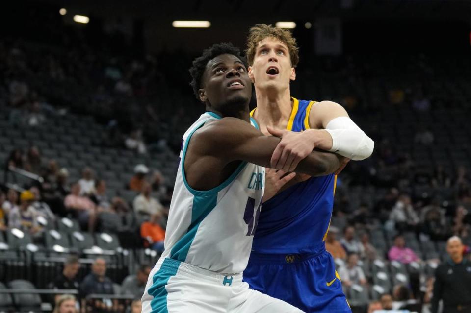 Jul 5, 2023; Sacramento, CA, USA; Charlotte Hornets center James Nnaji (left) blocks out Golden State Warriors forward Mikael Jantunen (right) during the first quarter at Golden 1 Center. Mandatory Credit: Darren Yamashita-USA TODAY Sports