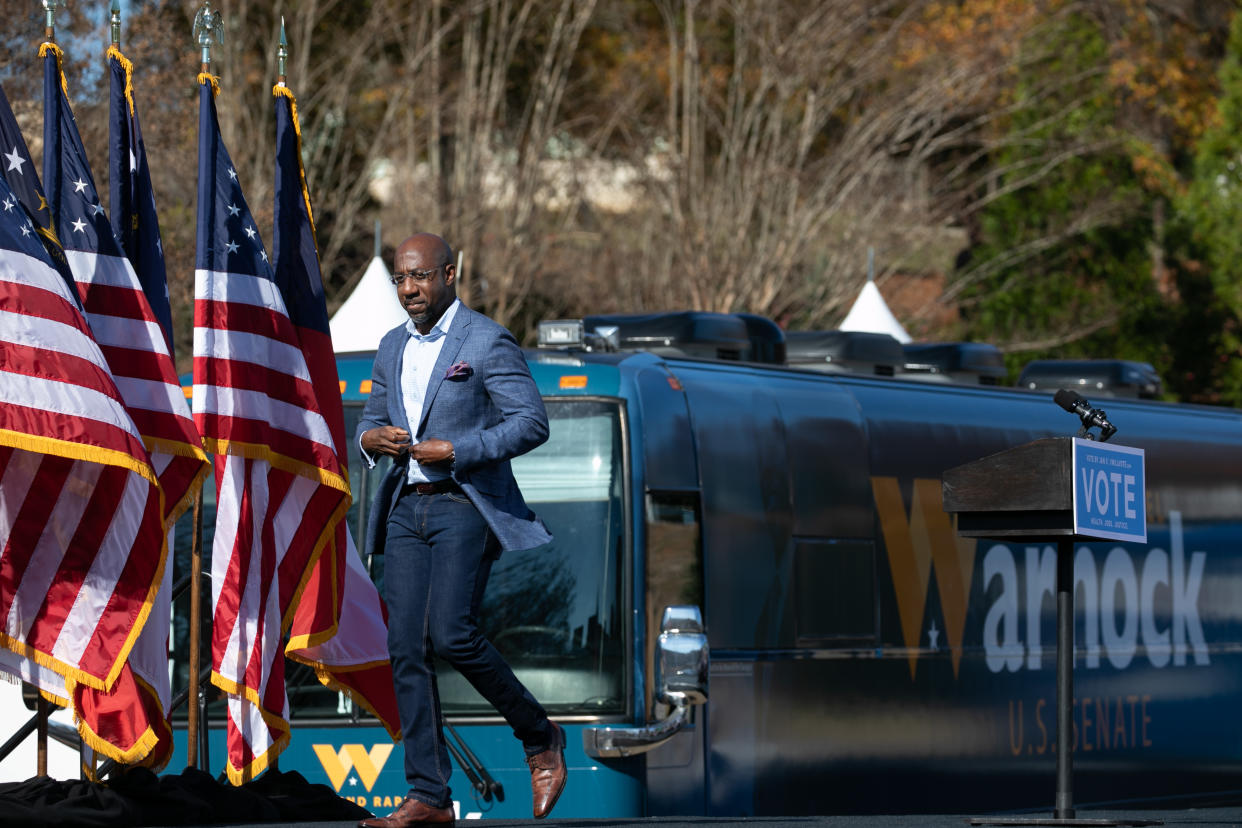 Georgia Democratic Senate candidate Rev. Raphael Warnock leaves the stage after addressing the crowd during a drive-in rally in Columbus, Georgia. (Photo by Jessica McGowan/Getty Images)