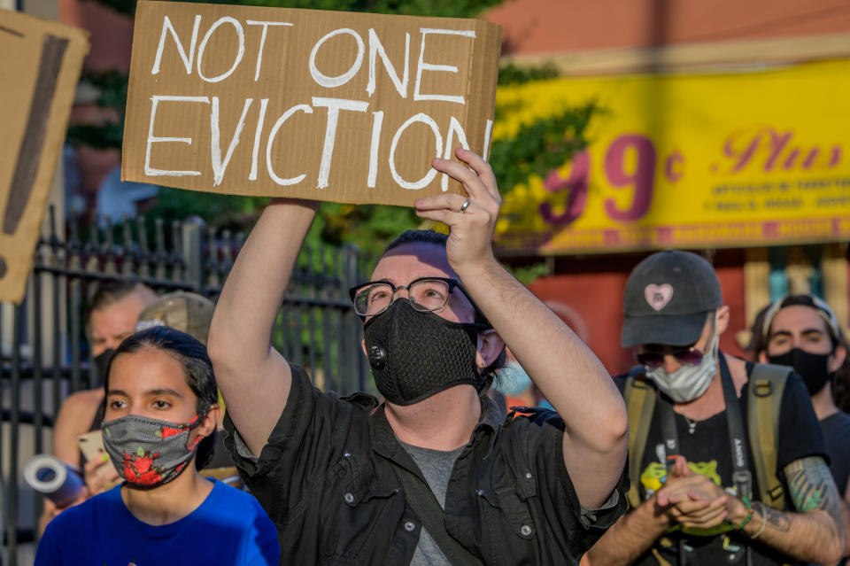 A participant holding a Not One Eviction sign at the protest. Tenants and Housing Activists dropped banners from their buildings and organized a march in the streets of Bushwick demanding the city to cancel rent immediately as the financial situation for many New Yorkers remains the same, strapped for cash and out of work. (Erik McGregor/LightRocket via Getty Images)