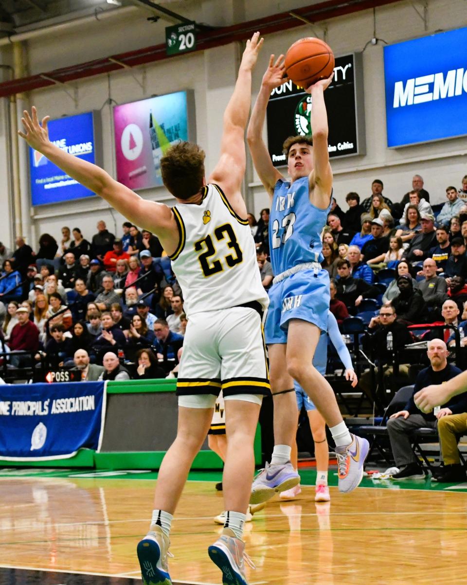 York’s Ryan Cummins, right, lofts a shot over Medomak Valley’s Finn Parmley during the Class B South quarterfinals Friday at the Portland Expo