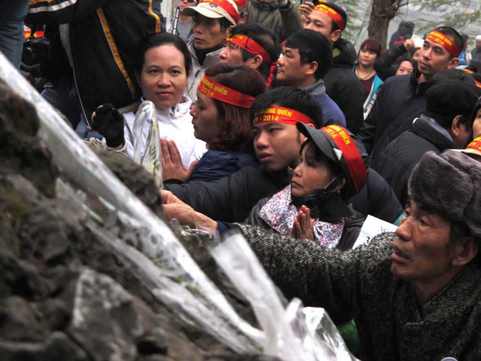 Anti-China protestors lay wreaths at a pagoda in the Vietnamese capital on Sunday, Feb. 16, 2014 to make the 35th anniversary a border war between China and Vietnam. Vietnam is wary of all forms of public protest and often quashes ant-China gatherings (AP Photo/Chris Brummitt)