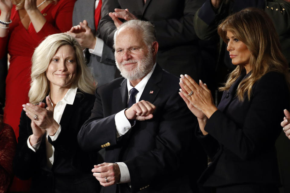 FILE - In this Feb. 4, 2020 file photo, Rush Limbaugh reacts as first Lady Melania Trump, and his wife Kathryn, applaud, as President Donald Trump delivers his State of the Union address to a joint session of Congress on Capitol Hill in Washington. Limbaugh, the talk radio host who became the voice of American conservatism, has died. (AP Photo/Patrick Semansky, File)