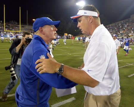 Aug 3, 2014; Canton, OH, USA; New York Giants coach Tom Coughlin (left) and Buffalo Bills coach Doug Marrone shake hands after the 2014 Hall of Fame game at Fawcett Stadium. Kirby Lee-USA TODAY Sports