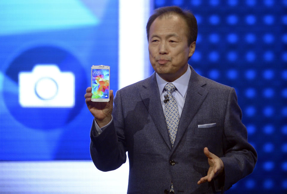 Samsung CEO J.K. Shin presents the new Samsung Galaxy S5 at the Mobile World Congress, the world's largest mobile phone trade show in Barcelona, Spain, Monday, Feb. 24, 2014. Expected highlights include major product launches from Samsung and other phone makers, along with a keynote address by Facebook founder and chief executive Mark Zuckerberg. (AP Photo/Manu Fernandez)