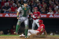 Los Angeles Angels' Mike Trout scores without a throw to Oakland Athletics catcher Sean Murphy, left, on an infield hit by Luis Rengifo during the sixth inning of a baseball game in Anaheim, Calif., Saturday, May 21, 2022. (AP Photo/Alex Gallardo)