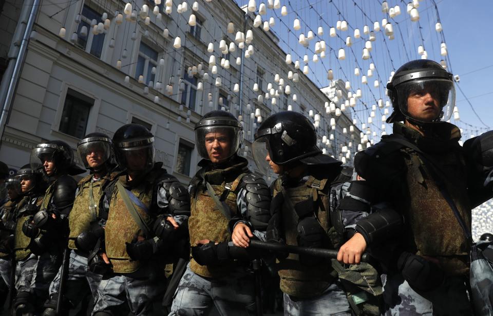 Police block a street during an unsanctioned rally in the center of Moscow, Russia, Saturday, July 27, 2019. Russian police clashed with demonstrators and have arrested some hundreds in central Moscow during a protest demanding that opposition candidates be allowed to run for the Moscow city council. (AP Photo/ Pavel Golovkin)