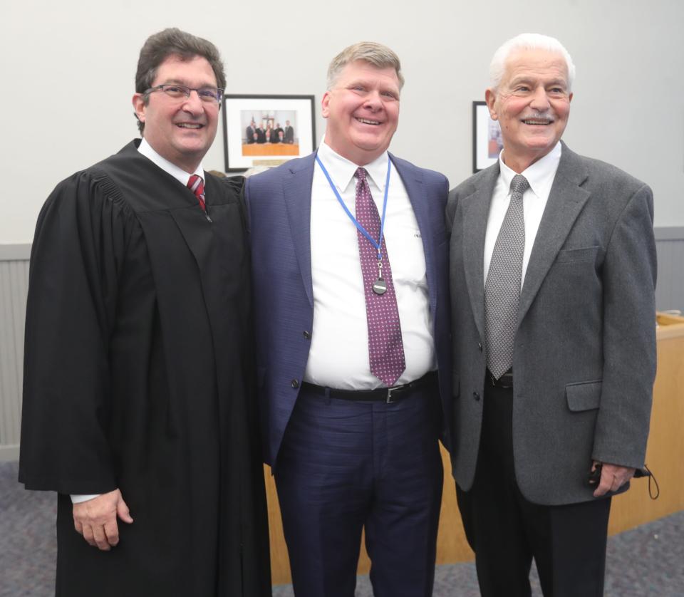 Ninth District Court of Appeals Judge Tom Teodosio, left, former Munroe Falls Mayor James Armstrong and new Mayor Allen Mavrides during Mavrides' swearing-in ceremony.