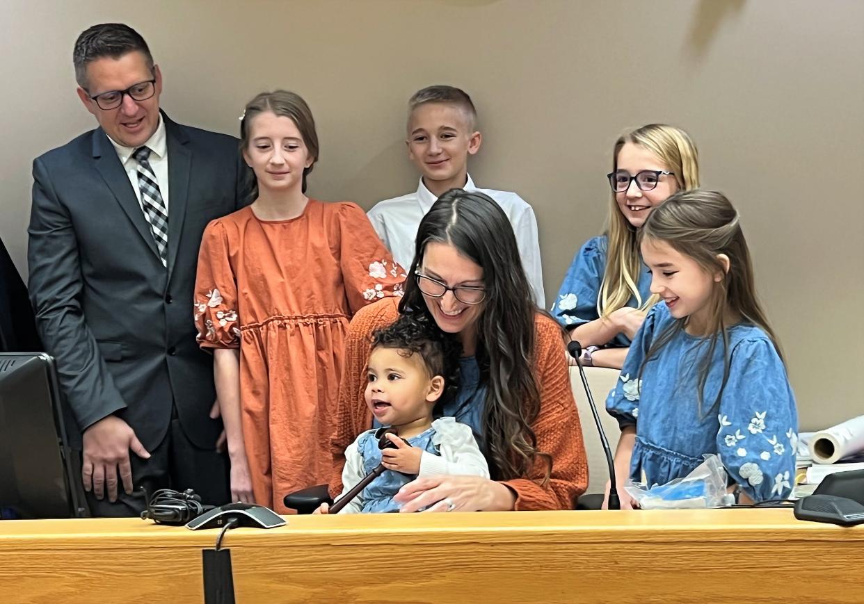 The Miller family celebrates the official addition of Gracelynn, middle, to the family after her adoption was confirmed Tuesday, Nov. 22, 2022.