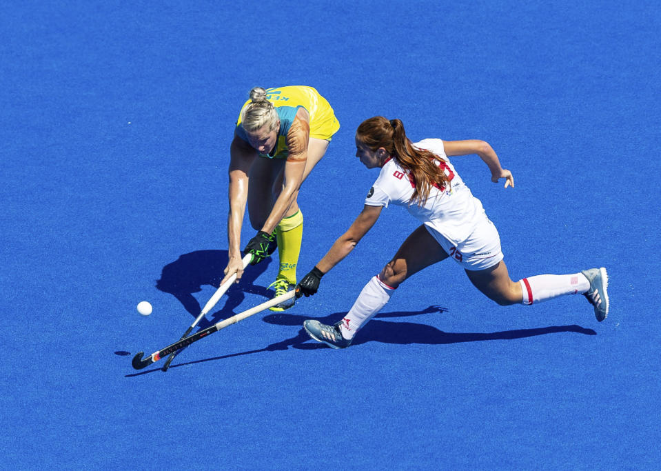 Spain's Begona Garcia, right and Australia's Jodie Kenny vie for the puck during the bronze medal match of the Women's Hockey World Cup at the Lee Valley Hockey and Tennis Centre in London, Sunday Aug. 5 2018. (Paul Harding/PA via AP)