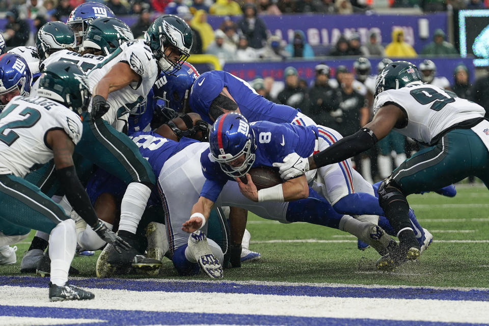 New York Giants quarterback Daniel Jones (8) crosses the goal line for a touchdown against the Philadelphia Eagles during the third quarter of an NFL football game, Sunday, Dec. 11, 2022, in East Rutherford, N.J. (AP Photo/Bryan Woolston)