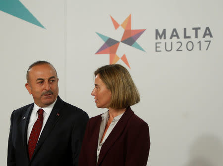 Turkey's Foreign Minister Mevlut Cavusoglu (L) talks with High Representative of the European Union for Foreign Affairs, Federica Mogherini, before a meeting with European Union Foreign Ministers in Valletta, Malta April 28, 2017. REUTERS/Darrin Zammit Lupi