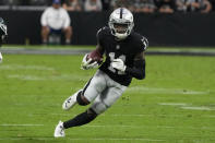 Las Vegas Raiders wide receiver Henry Ruggs III (11) carries the ball during the second half of an NFL football game against the Philadelphia Eagles, Sunday, Oct. 24, 2021, in Las Vegas. Former Las Vegas Raiders player Henry Ruggs was sentenced Wednesday, Aug. 9, 2023, in Las Vegas, to at least three years in a Nevada prison for killing a woman in a fiery crash while driving his sports car drunk at speeds up to 156 mph on a city street nearly two years ago. (AP Photo/Rick Scuteri, File)