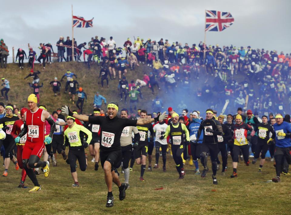 Competitors gesture as they start the Tough Guy event in Perton, central England