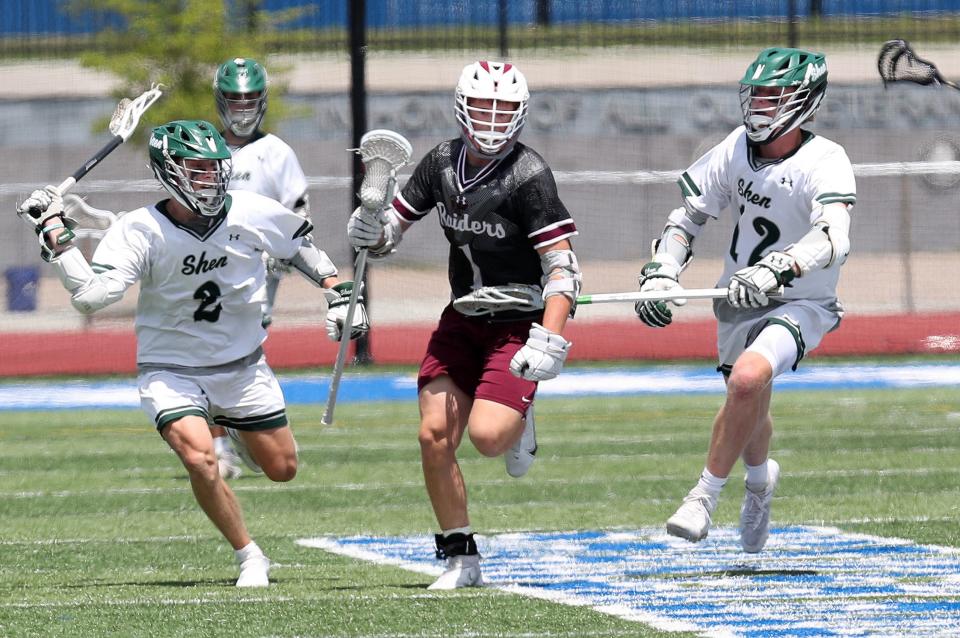 Scarsdale's Colby Baldwin (1) breaks away from Shenendehowa defenders during the boys lacrosse Class A regional final at Shaker High School in Albany on Saturday. Scarsdale won the game.