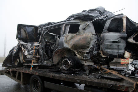 The damaged vehicle that drove over a mine while transporting members of the Organization for Security and Cooperation in Europe (OSCE), who were killed and injured from the incident on Sunday, is moved from the scene in Luhansk region, Ukraine, April 23, 2017. REUTERS/Alexander Ermochenko