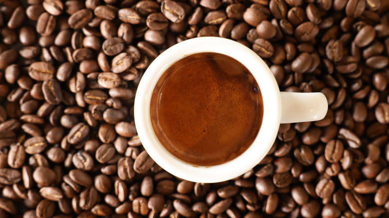 Espresso shot atop coffee beans