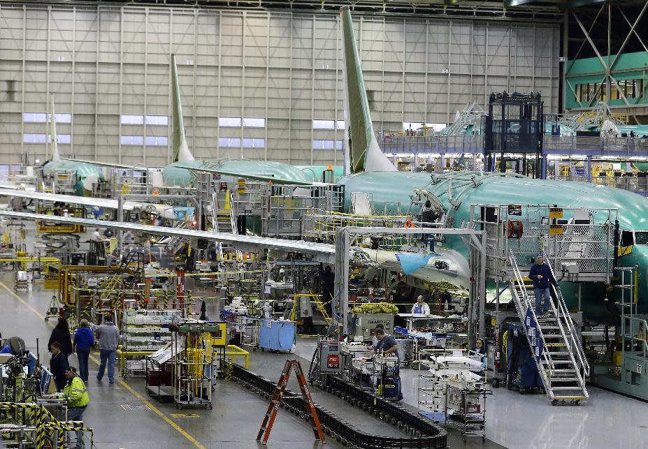 Workers assemble Boeing Co. next-generation 737 airplanes, Tuesday, Jan. 29, 2013 at the company's 737 assembly facility in Renton, Wash. On Jan. 25, 2013, Boeing began assembling next-generation 737 passenger airplanes at an increased rate of 38 planes per month. (AP Photo/Ted S. Warren)