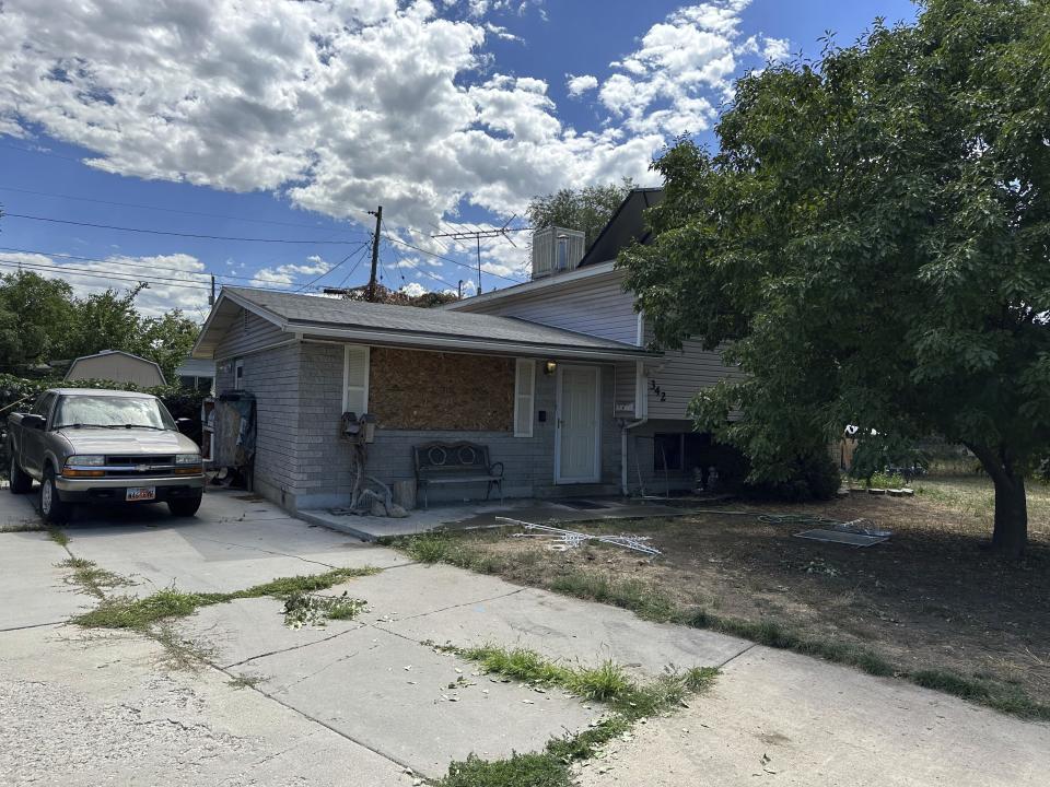 This photo shows a boarded up window and the front of the house of Craig Robertson, who was killed by FBI agents Wednesday during a confrontation after making violent threats against President Joseph Biden and other public officials, Thursday, Aug. 10, 2023 in Provo, Utah. (AP Photo/Sam Metz)
