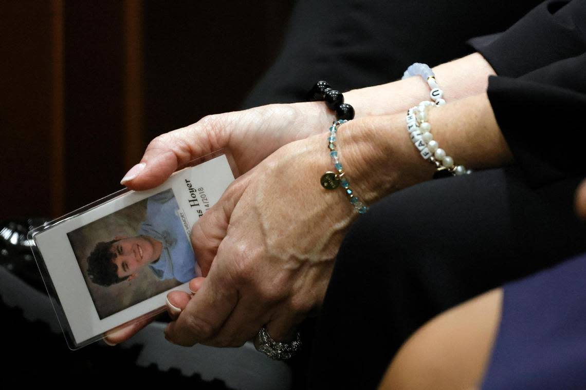 Gena Hoyer holds a photograph of her son, Luke, who was killed in the 2018 shootings, as she awaits the verdict in the trial of Marjory Stoneman Douglas High School shooter Nikolas Cruz at the Broward County Courthouse in Fort Lauderdale on Thursday, Oct. 13, 2022. 