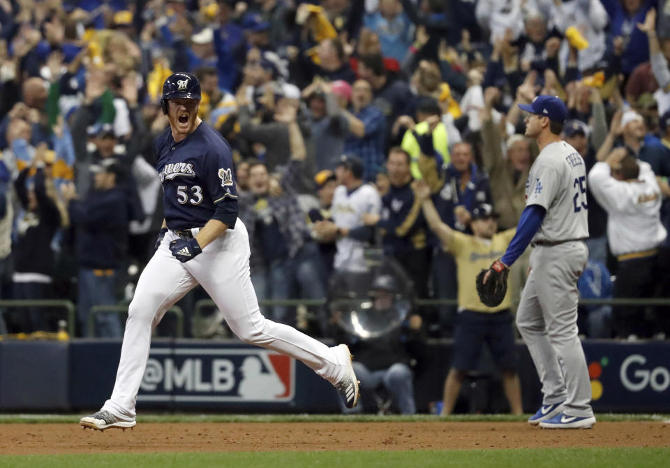 Milwaukee Brewers' Brandon Woodruff (53) celebrates after hitting a home run during the third inning of Game 1 of the National League Championship Series baseball game against the Los Angeles Dodgers Friday, Oct. 12, 2018, in Milwaukee. (AP Photo/Jeff Roberson)