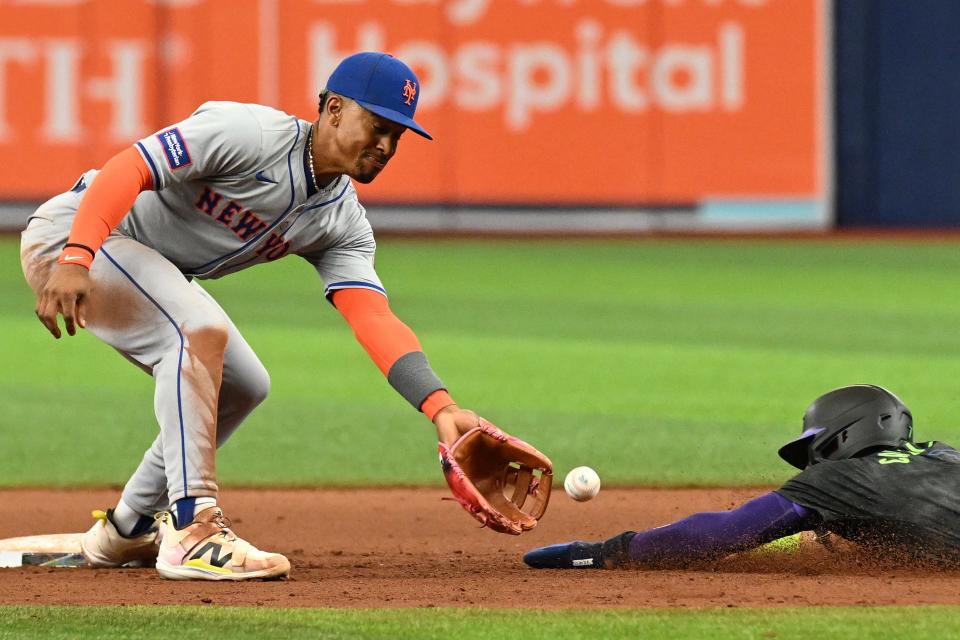 New York Mets short stop Francisco Lindor (12) waits for the ball as Tampa Bay Rays shortstop Jose Caballero (7) slides into second base in the seventh inning on May 5, 2024, at Tropicana Field.