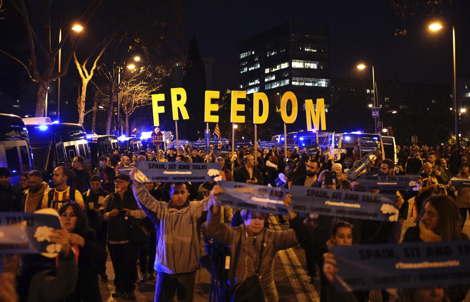 Catalan pro-independence demonstrators block a road as they protest outside the Camp Nou stadium ahead of a Spanish La Liga soccer match between Barcelona and Real Madrid in Barcelona, Spain, Wednesday, Dec. 18, 2019. Thousands of Catalan separatists are planning to protest around and inside Barcelona's Camp Nou Stadium during Wednesday's match against fierce rival Real Madrid. (AP Photo/Felipe Dana)