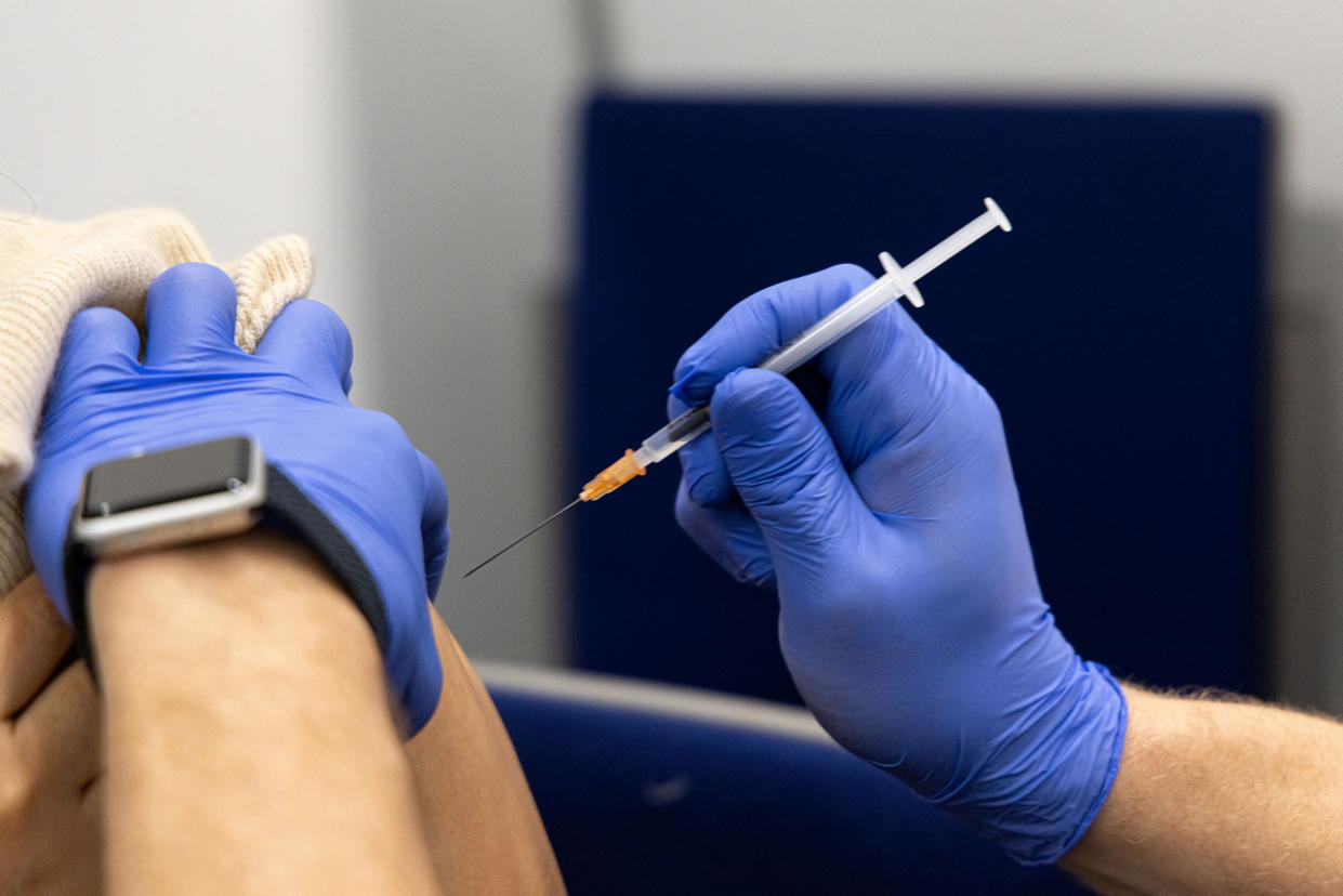 A woman gets a dose of Comirnaty, the Pfizer-BioNTech vaccine against the coronavirus disease (COVID-19), one day before the start of compulsory vaccination in Austria during the ongoing coronavirus disease (COVID-19) pandemic, at a vaccination centre in Salzburg, Austria, January 31, 2022. REUTERS/Lukas Barth