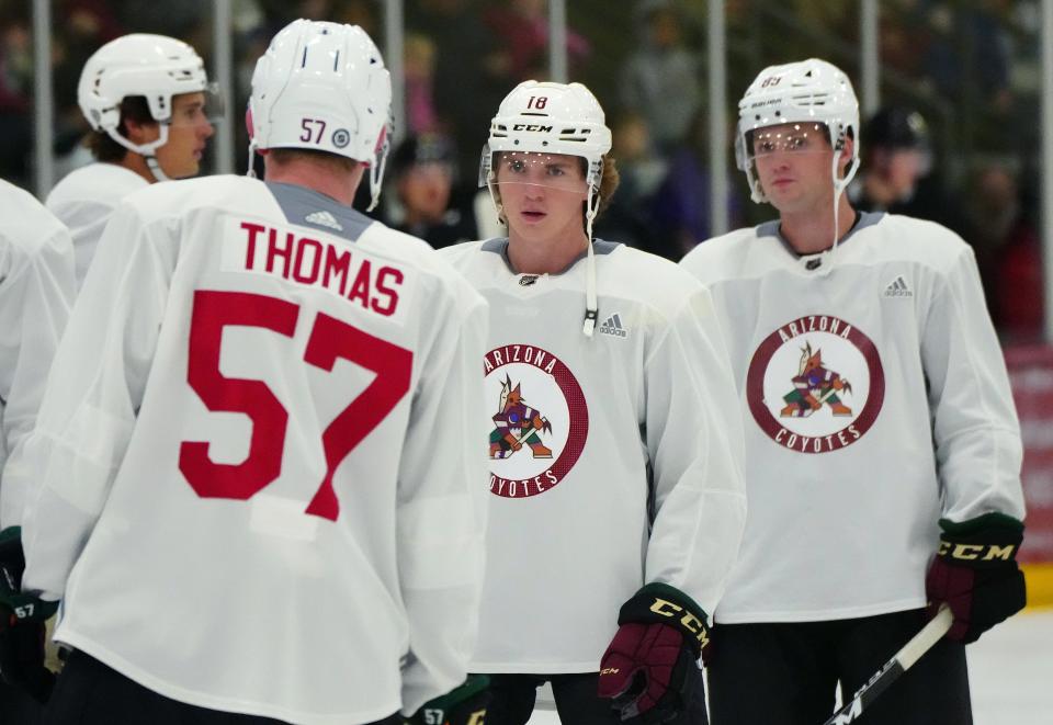 Arizona Coyotes forward Logan Cooley (18) stands with teammates prior to a scrimmage at the Ice Den in Scottsdale on July 15, 2022.