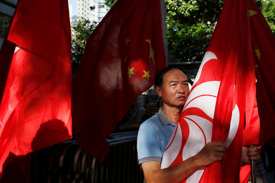 A pro-China supporter holds a Hong Kong flag