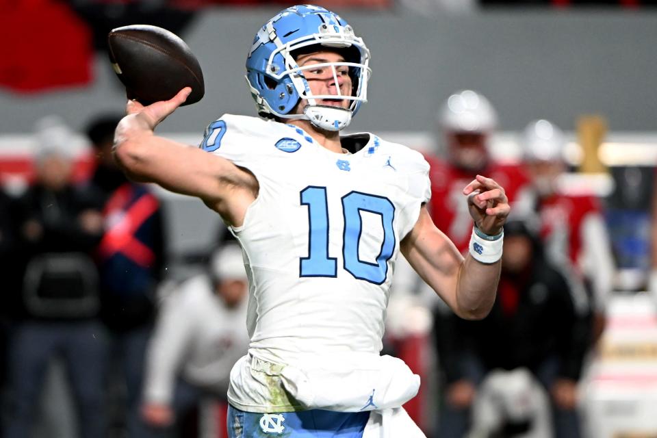 North Carolina Tar Heels quarterback Drake Maye (10) throws a pass against the North Carolina State Wolfpack during the first half at Carter-Finley Stadium.