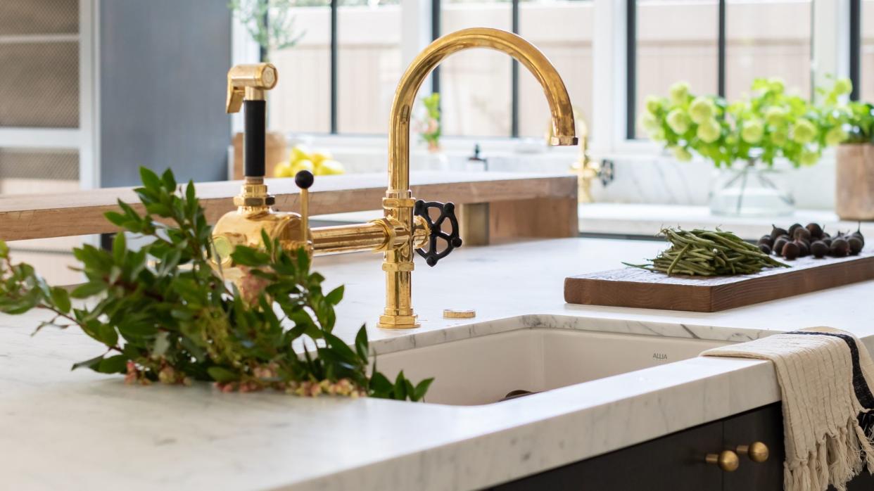  Ceramic kitchen sink, marble worktop, brass tap. 