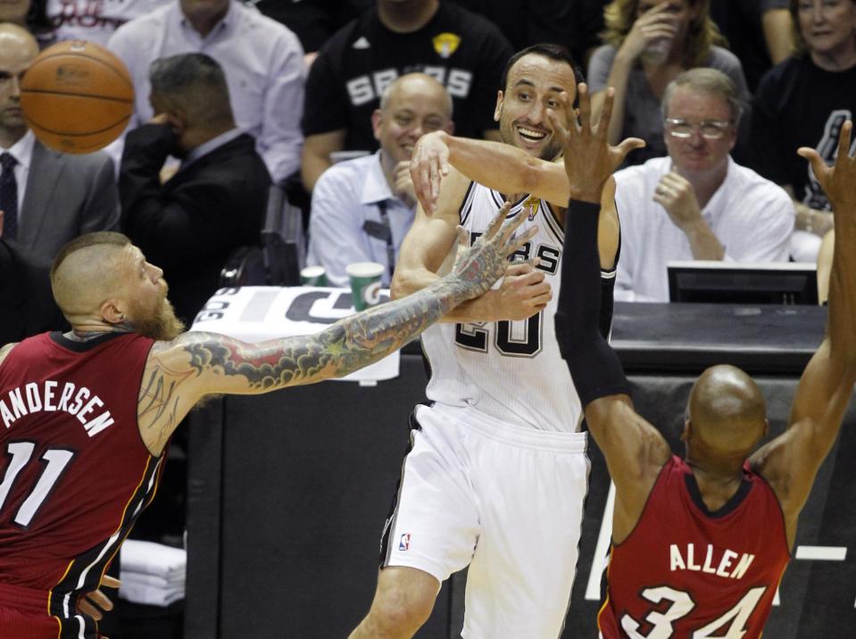 San Antonio Spurs' Manu Ginobili (C) of Argentina passes over Miami Heat's Chris Andersen (L) and Ray Allen during the first quarter in Game 1 of their NBA Finals basketball series in San Antonio, Texas June 5, 2014. REUTERS/Mike Stone (UNITED STATES - Tags: SPORT BASKETBALL)