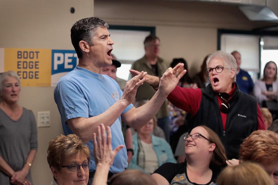 A woman shouts down a protester as Democratic presidential candidate and South Bend, Indiana, Mayor Pete Buttigieg was hosting a town hall meeting at the Lions Den on April 16, 2019 in Fort Dodge, Iowa.