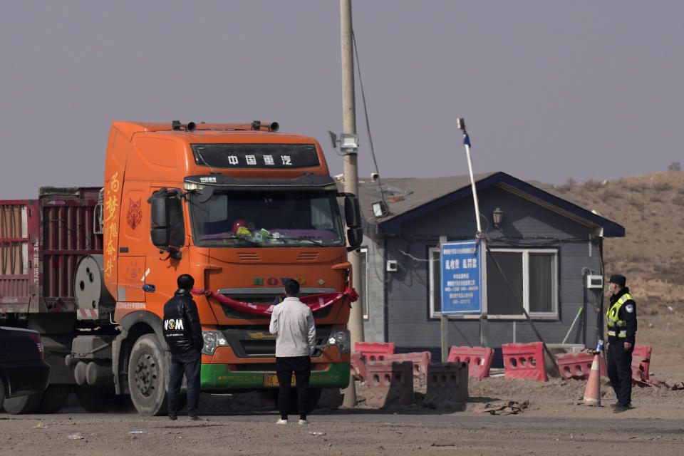 A truck is stopped at a checkpoint along a road in Qingtongxia on northern China's Ningxia Hui Autonomous Region leading to the site of a collapsed open pit mine in Alxa League in northern China's Inner Mongolia Autonomous Region, Friday, Feb. 24, 2023. Rescuers have changed their approach to search for dozens of people missing from a coal mine collapse in northern China to avoid further landslides, state broadcaster CCTV reported Friday. (AP Photo/Ng Han Guan)