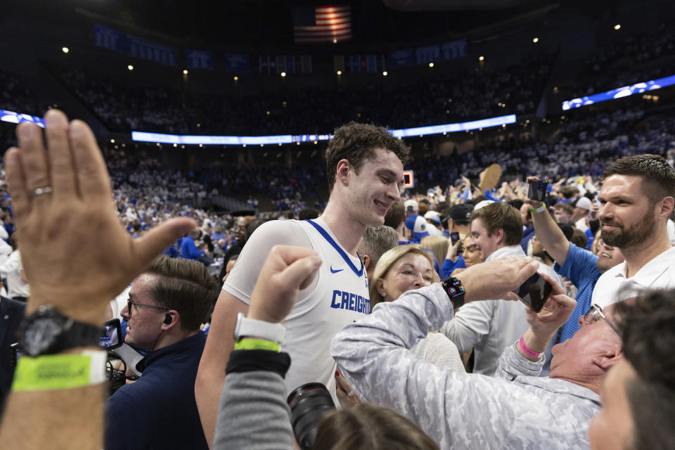 Creighton's Ryan Kalkbrenner hugs fans following Creighton's 85-66 win over UConn in an NCAA college basketball game Tuesday, Feb. 20, 2024, in Omaha, Neb. (AP Photo/Rebecca S. Gratz)